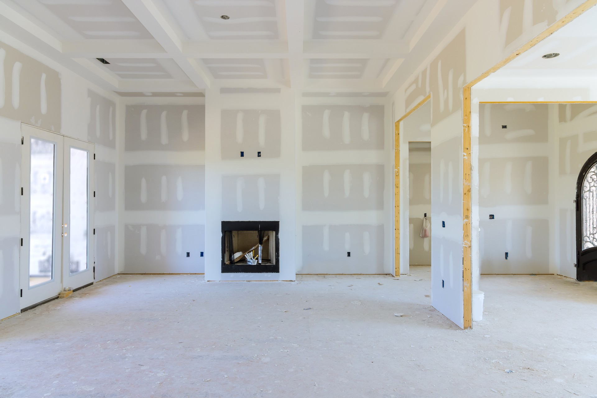 To prepare the walls of a newly constructed house to be painted, finishing putty is applied to the walls